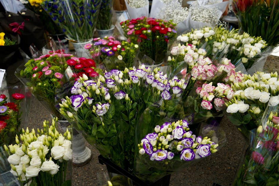 A vibrant display of fresh floral bouquets arranged on a table at southnorwoodflorist.co.uk, featuring a variety of flowers including purple and white lisianthus, pink and white roses, and small brigh